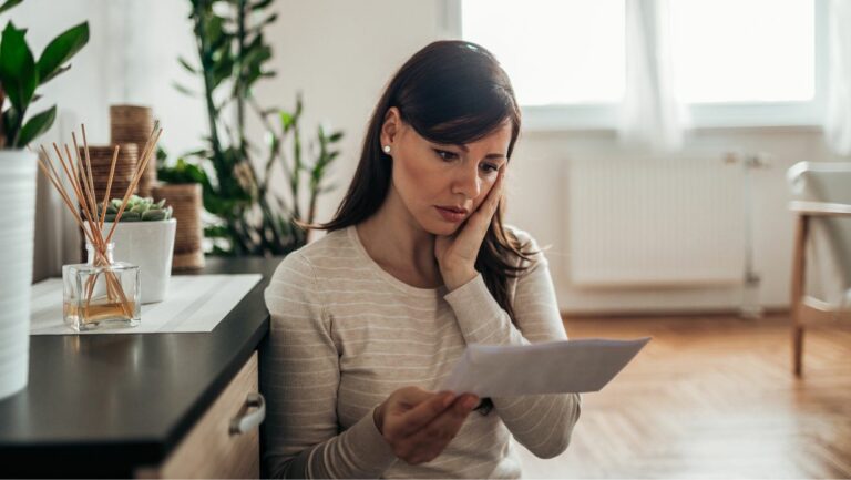 Woman looking at debt lawsuit letter that needs credit card debt attorney response