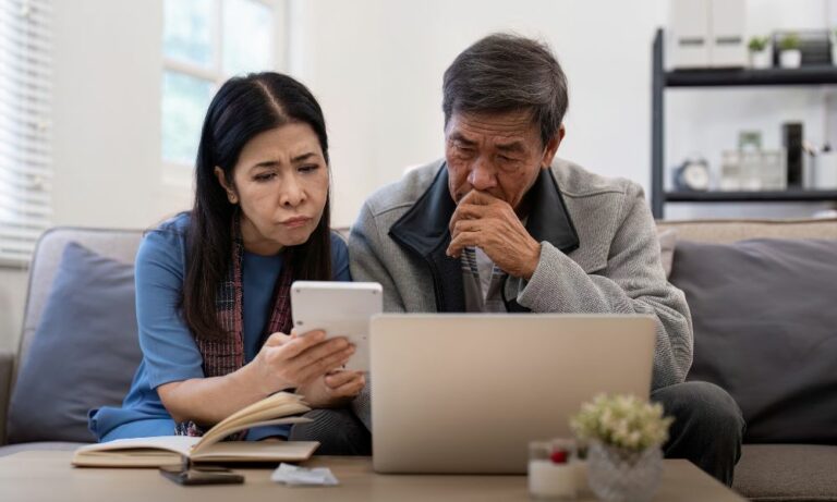 couple looking at garnished bank statements and needing credit card debt attorney