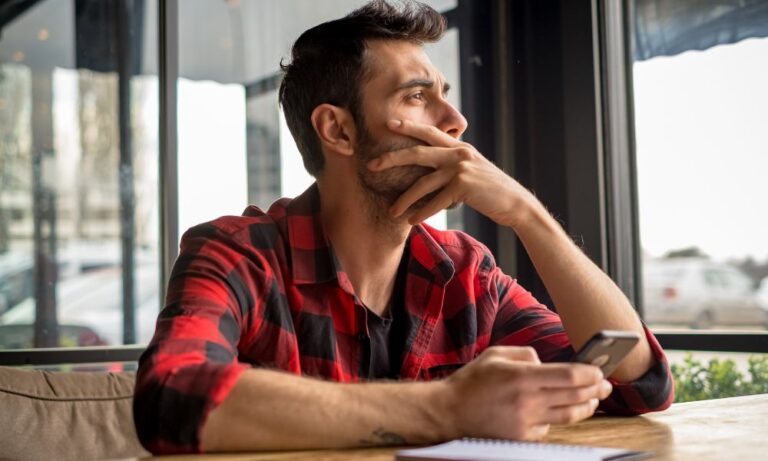stressed man considering whether to hire a debt attorney